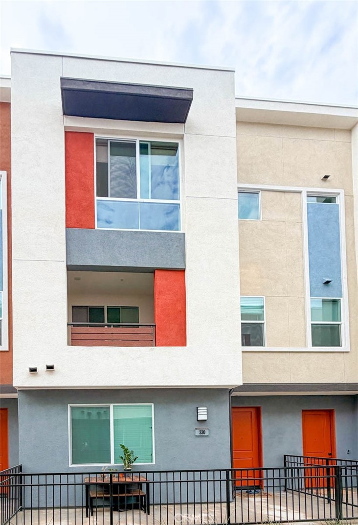 The front of this tri-level 4 bedrooms condo with enclosed front porch. Middle unit with neighbor on each side. This com - 1814 E 1st Street 330, Santa Ana CA 92705 - photo 1
