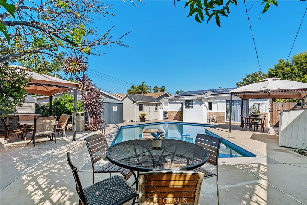 Spacious backyard with a clean, refreshing pool - 1910 S Van Ness Ave, Santa Ana CA 92707 - photo 1