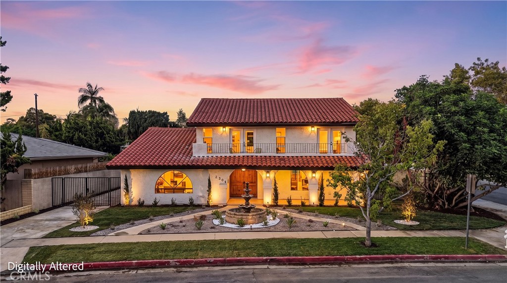 Striking Spanish-Style Curb Appeal — A beautifully remodeled Spanish residence with classic tile roofing, arched archite - 2301 N Lowell, Santa Ana CA 92706 - photo 1