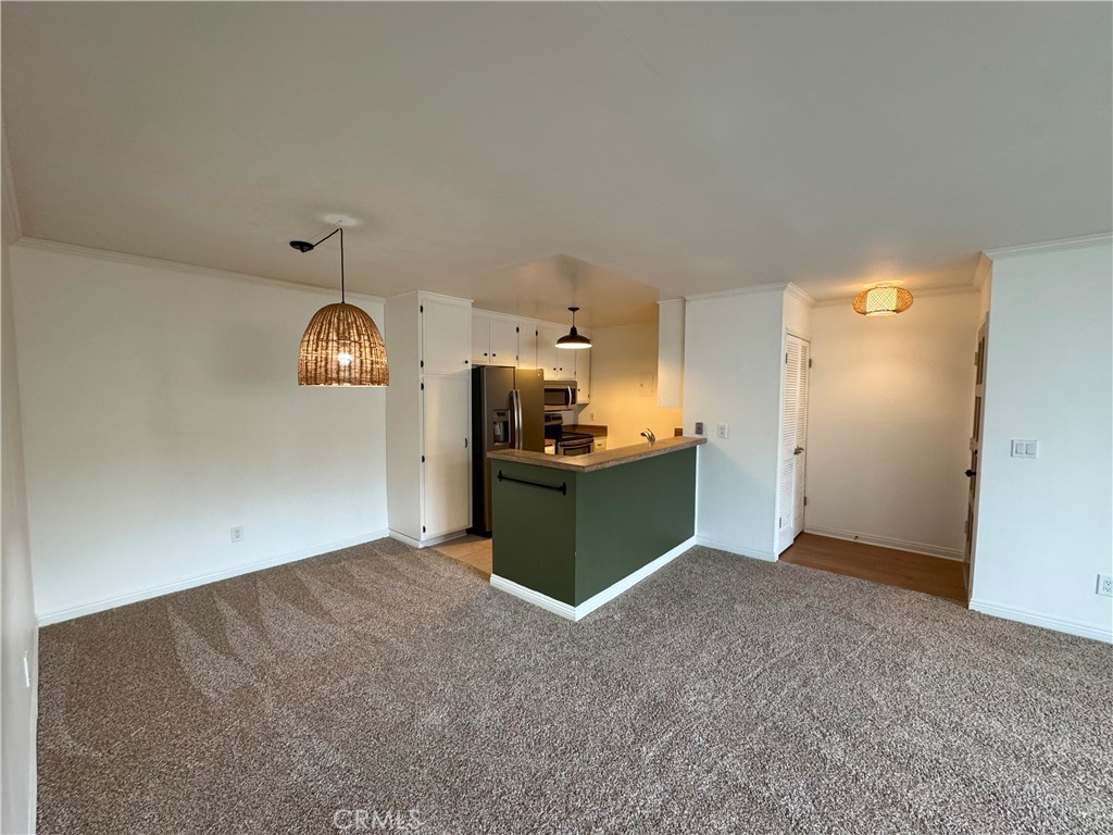 Open floor plan, with kitchen opening to dining nook and large living room. - 2521 W Sunflower Avenue, Santa Ana CA 92704 - photo 1