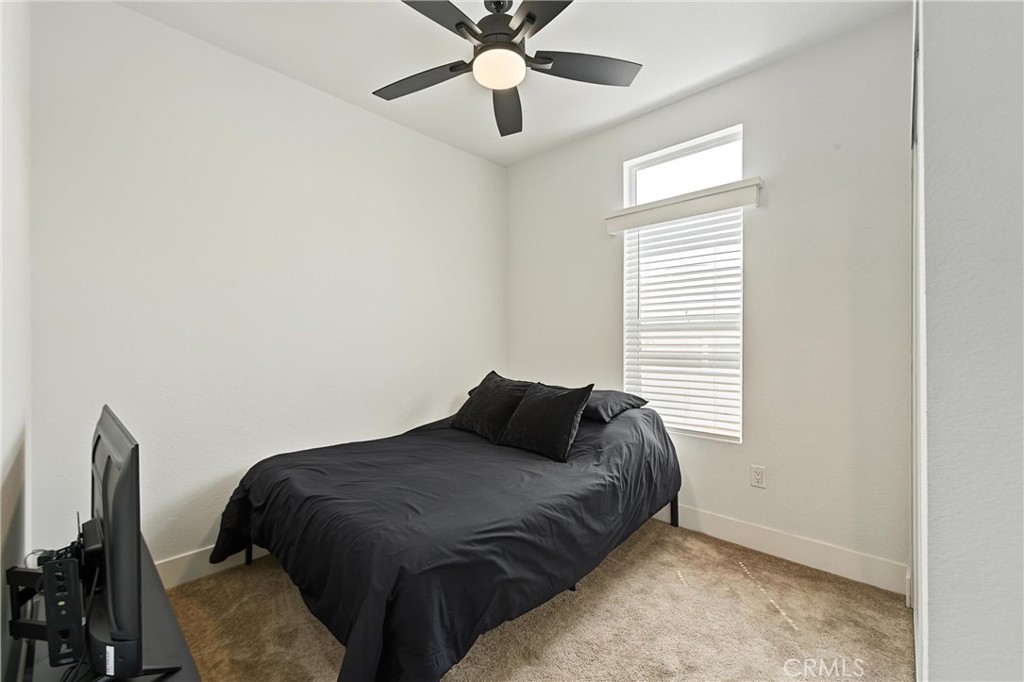 Nice size second bedroom with ceiling fan and mirrored closet doors. - 2767 W 1st Street 14, Santa Ana CA 92703 - photo 11