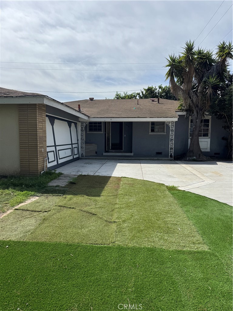 Mismatched artificial grass. Newer driveway in good condition. - 3618 W Crystal, Santa Ana CA 92704 - photo 1
