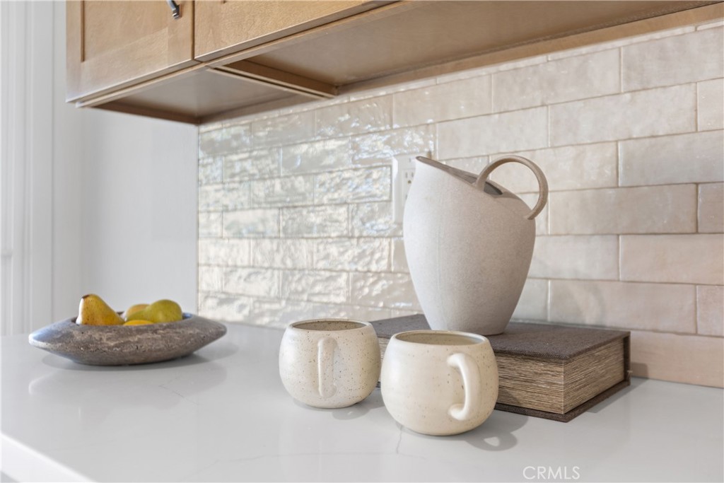 Fully remodeled kitchen with new cabinets, stainless appliances, and quartz counters, and tile backsplash - 3709 S Olive Street, Santa Ana CA 92707 - photo 15