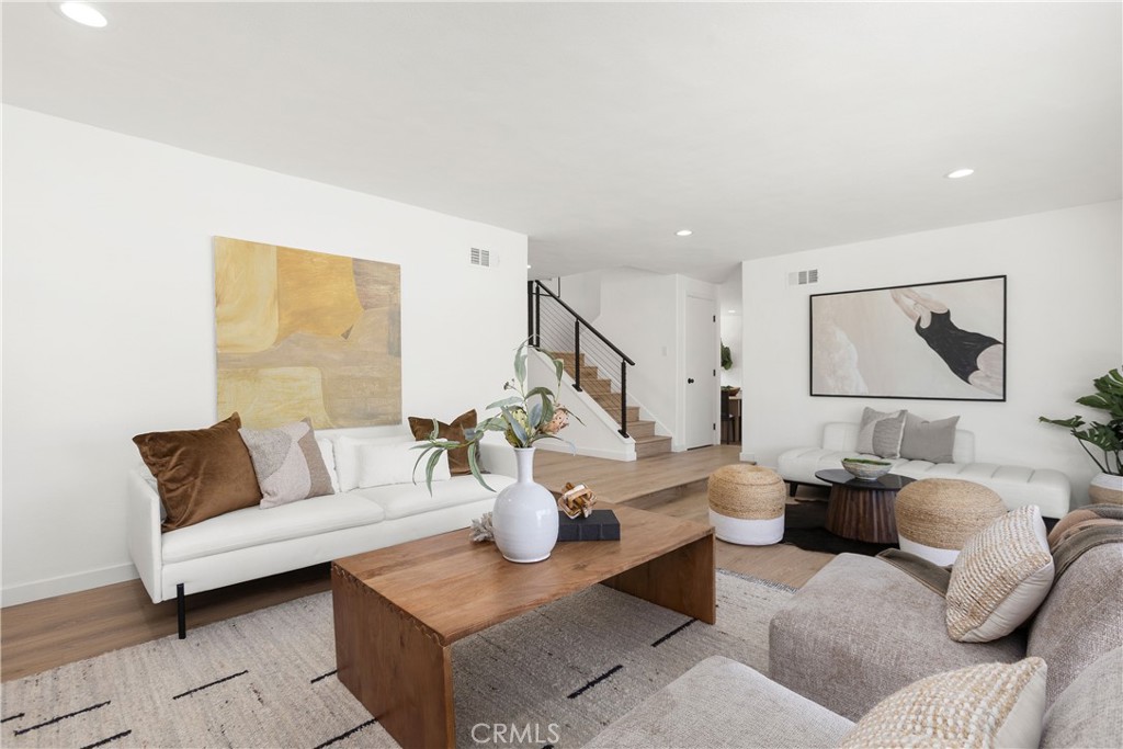 Living room with modern electric fireplace and direct access to outdoor patio and pool area - 3709 S Olive Street, Santa Ana CA 92707 - photo 27