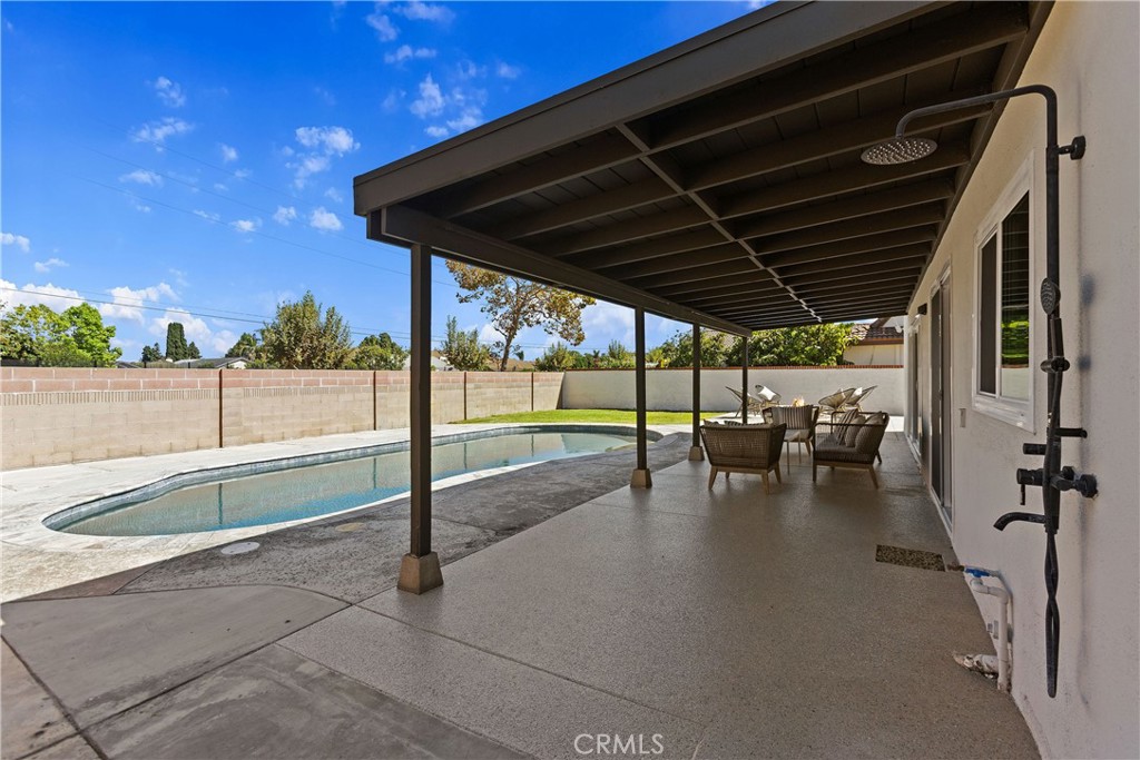 Covered outdoor patio with new epoxy floor and outdoor shower - 3709 S Olive Street, Santa Ana CA 92707 - photo 58