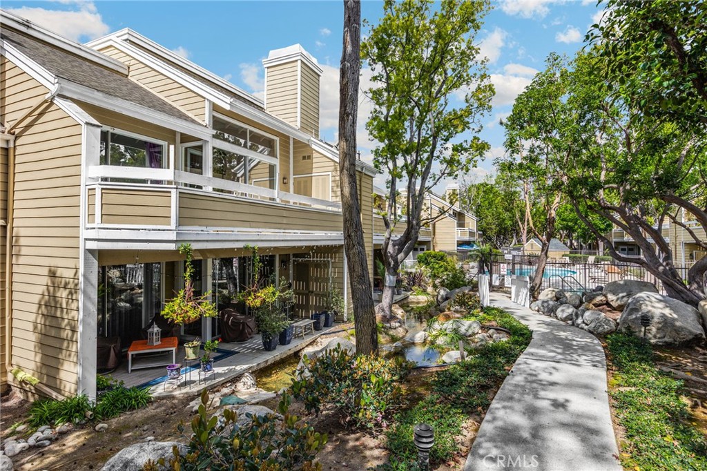 Upstairs unit offers the view of trees and babbling creek below. - 3740 S Bear St F, Santa Ana CA 92704 - photo 1