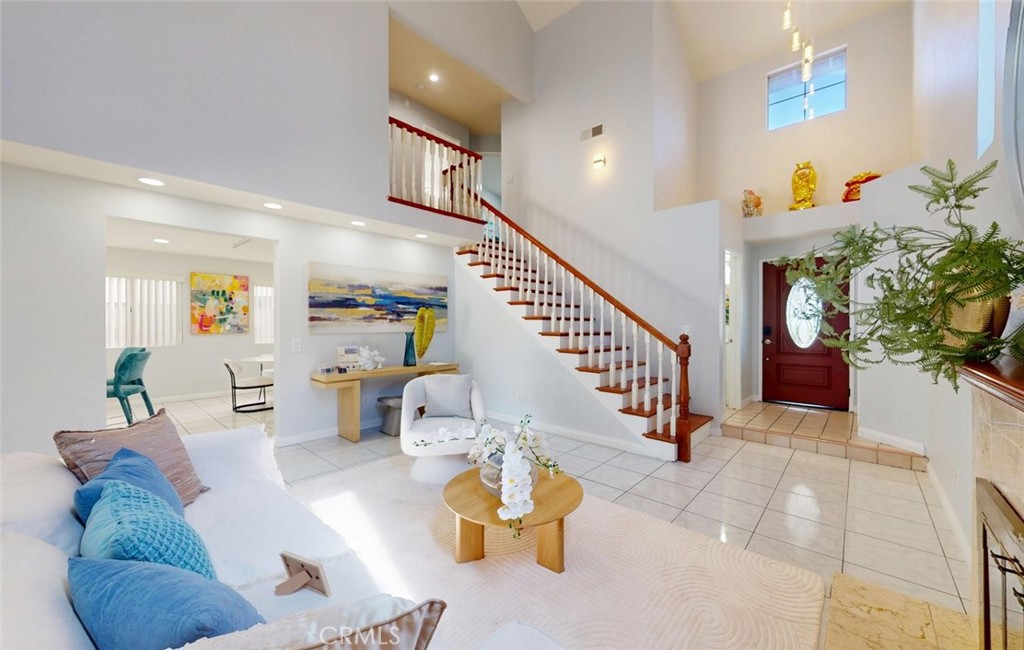Living room with vaulted ceiling staircase - 400 North Lisabeth, Santa Ana CA 92703 - photo 8