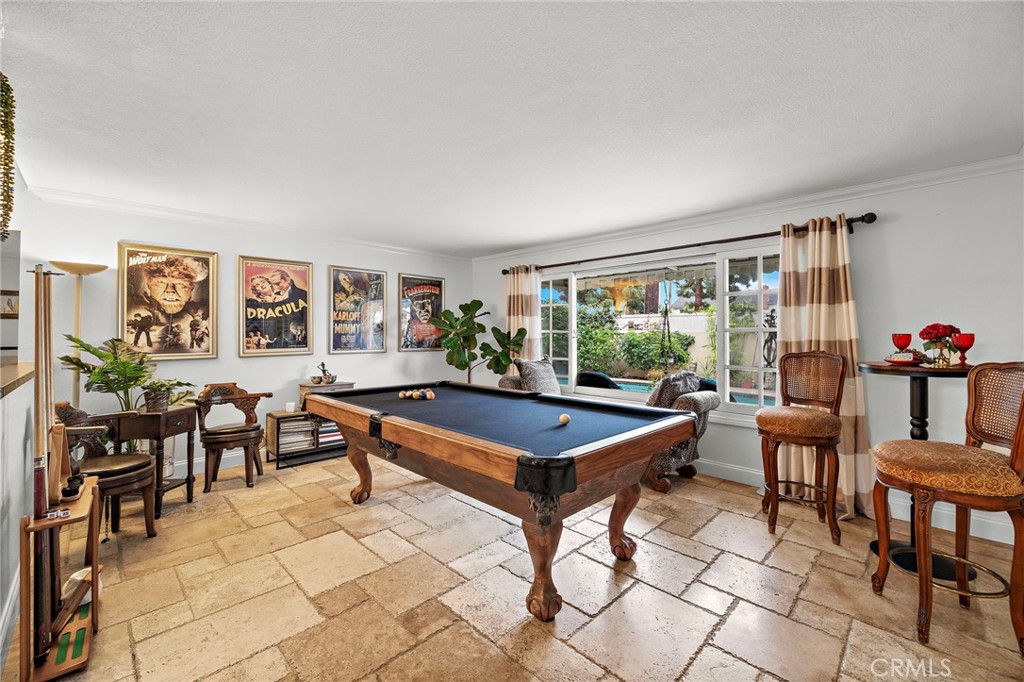 Gorgeous Formal Living Room with Chiseled-Edge Travertine Flooring and French Windows Overlooking Resort Backyard with P - 622 W Alpine Avenue, Santa Ana CA 92707 - photo 4