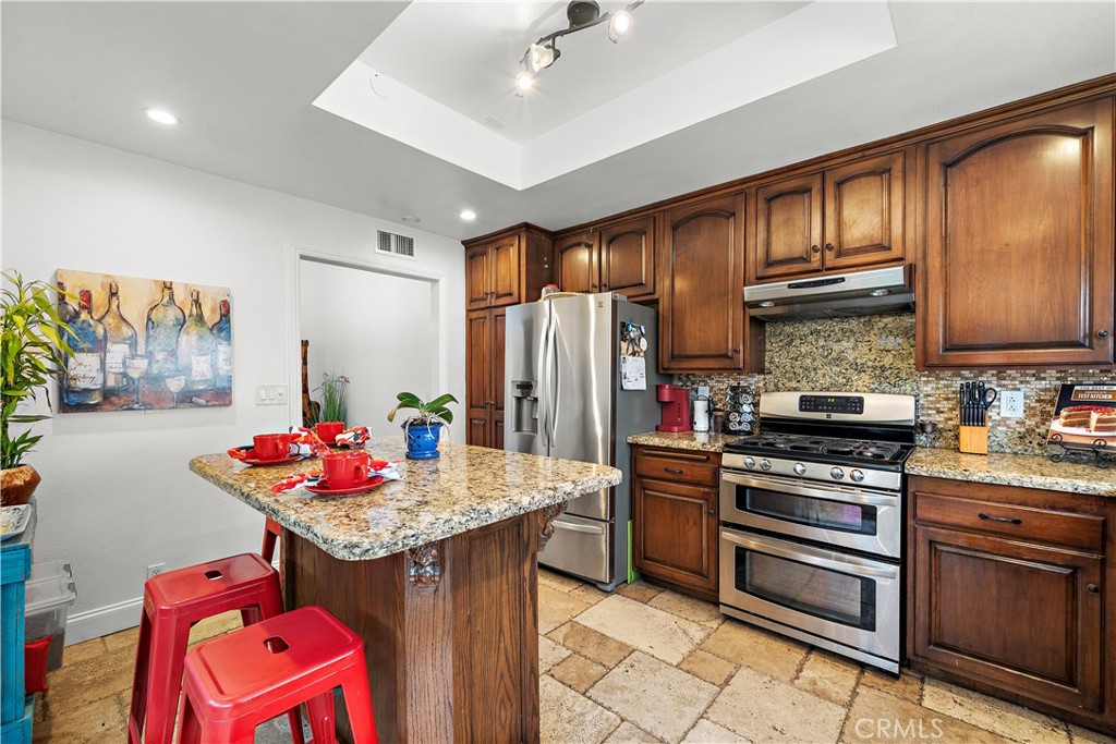 Chef's Dream Remodeled Kitchen with Granite Countertops, Glass Mosaic Tile Backsplash, Stainless Appliances, Beautiful C - 622 W Alpine Avenue, Santa Ana CA 92707 - photo 8