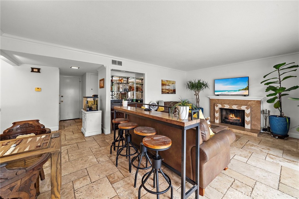 Spacious Inviting Family Room has Wet Bar with Glass Shelving, Fireplace, and French Sliders - 622 W Alpine Avenue, Santa Ana CA 92707 - photo 15