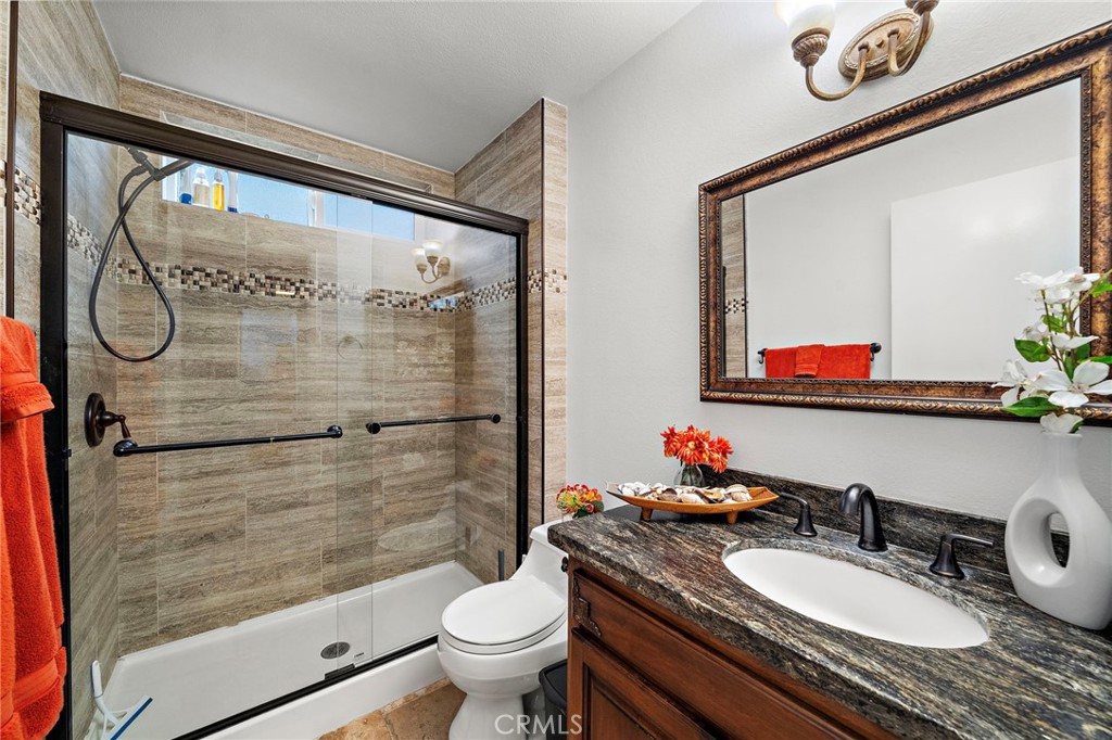 Remodeled Full Bath Downstairs with Oversized Walk-In Shower, Designer Tile Surround, Clear Glass Enclosure, and Granite - 622 W Alpine Avenue, Santa Ana CA 92707 - photo 18