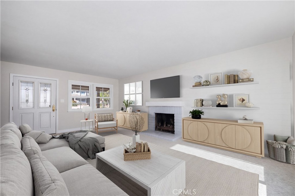 Virtual staged Living room is spacious and warmed by a gas fireplace. Natural light streams through the windows all day - 1200 Catalina Avenue, Seal Beach CA 90740 - photo 3