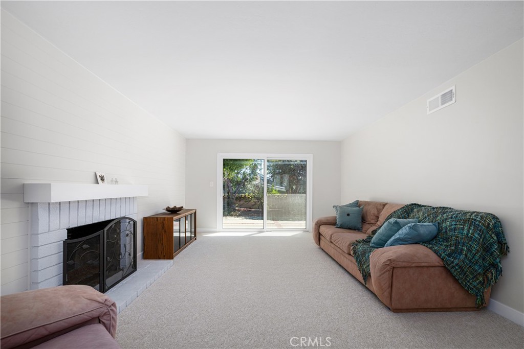Natural light floods this spacious living room. The gas fireplace adds charm and warmth to this family space. - 1200 Catalina Avenue, Seal Beach CA 90740 - photo 4