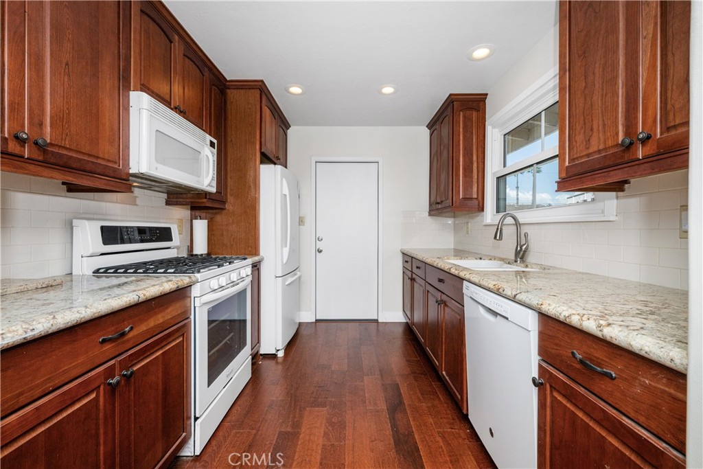 The kitchen has been remodeled wit wood cabinets, granite counters and recessed lights. - 1200 Catalina Avenue, Seal Beach CA 90740 - photo 12