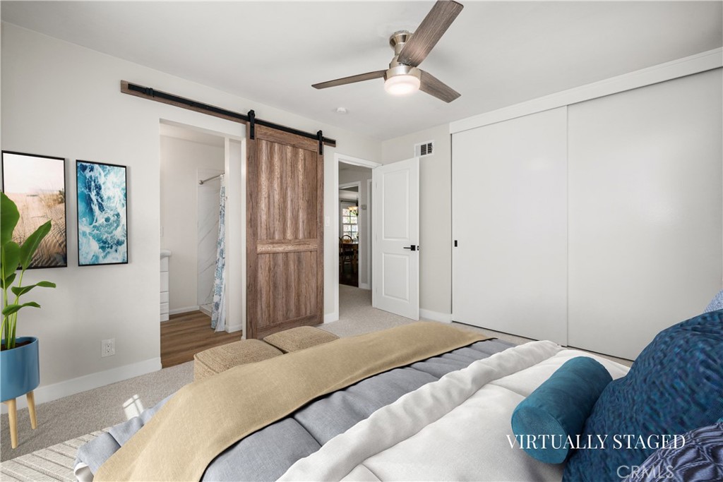 Main bedroom refreshed with new paint, carpet and ceiling fan. Barn door opens to the 3/4 bath. - 1200 Catalina Avenue, Seal Beach CA 90740 - photo 17