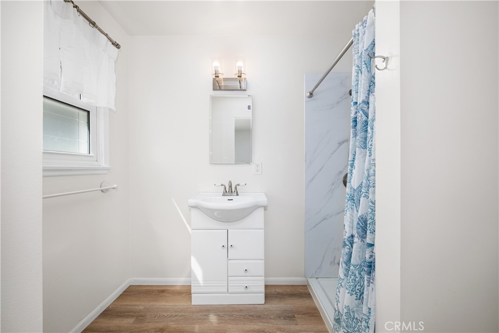 The remodel 3/4 main room bath has a spacious walk in shower and a vanity with additional storage. - 1200 Catalina Avenue, Seal Beach CA 90740 - photo 18