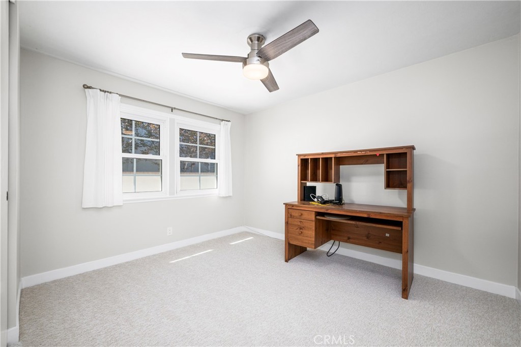 Secondary bedroom with new carpet, paint, ceiling fan and entry door. - 1200 Catalina Avenue, Seal Beach CA 90740 - photo 20