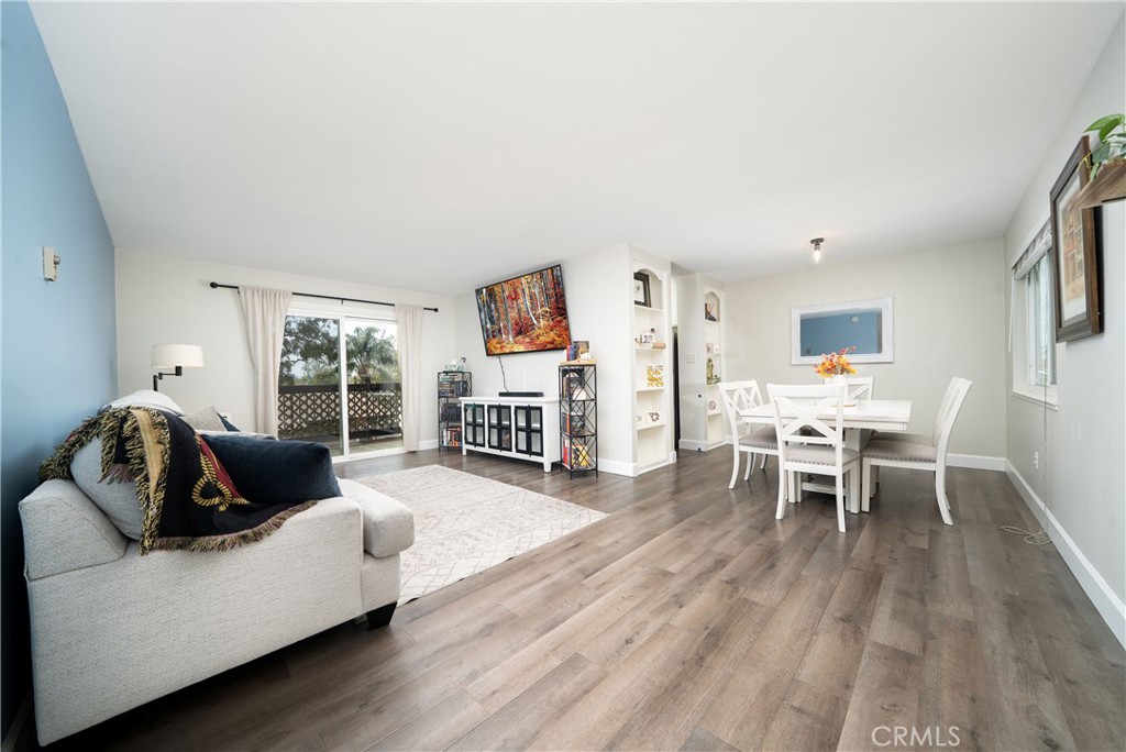 Spacious living room and dining room with access to private balcony - 12200 Montecito D312, Seal Beach CA 90740 - photo 1