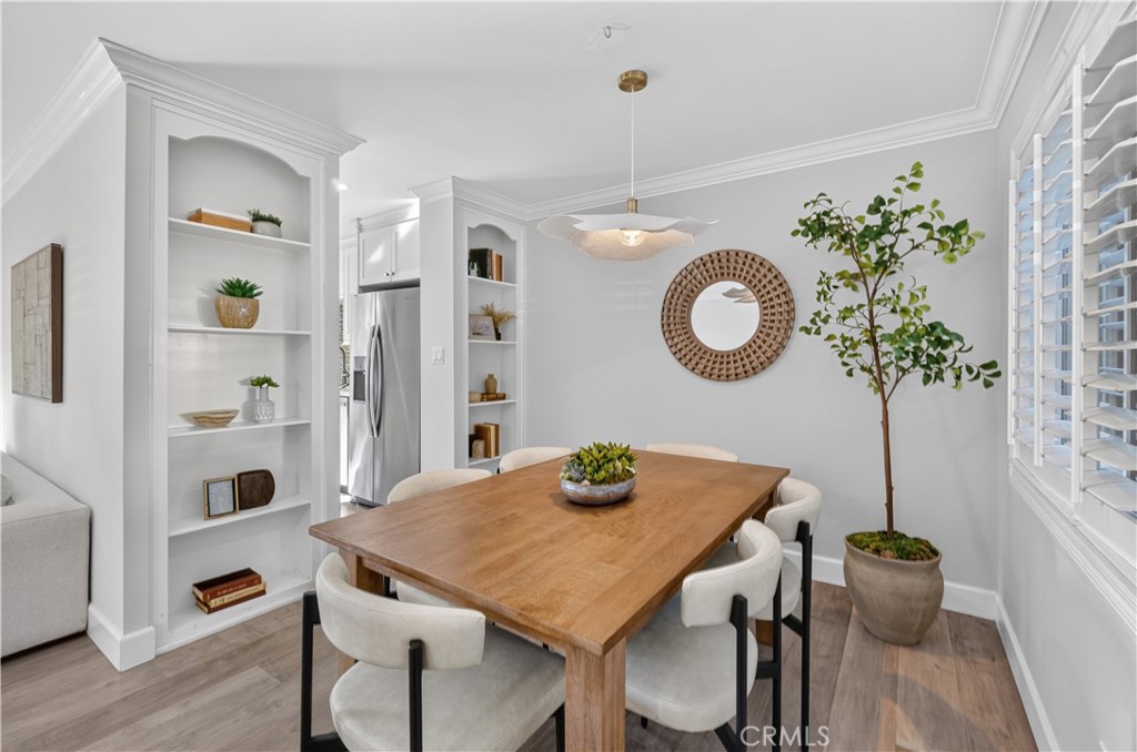 Dining area with built-in shelves and shutters add to the charm. - 12200 Montecito Road B112, Seal Beach CA 90740 - photo 6