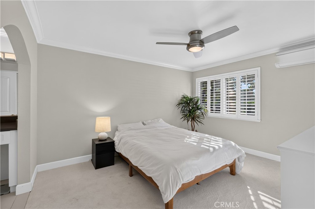 Primary Bedroom with archway to vanity counter, walk-in closet and en suite. - 12200 Montecito Road B112, Seal Beach CA 90740 - photo 15