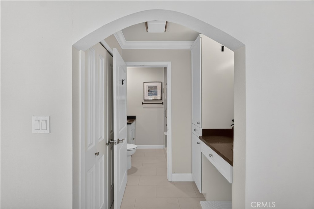 Primary Bedroom walk-in closet to the left, vanity counter with linen closet. Privacy door to the en suite. - 12200 Montecito Road B112, Seal Beach CA 90740 - photo 17