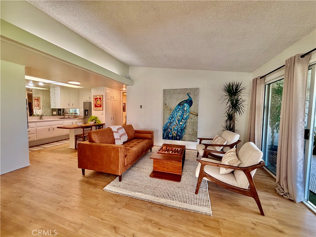 Spacious living room, abundant natural light, and seamless indoor-outdoor flow. - 13560 Medinac Lane 102 L, Seal Beach CA 90740 - photo 6