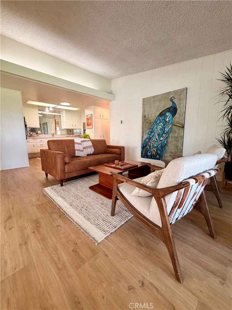 Open-concept living and dining areas create a versatile space for everyday living and entertaining. - 13560 Medinac Lane 102 L, Seal Beach CA 90740 - photo 7