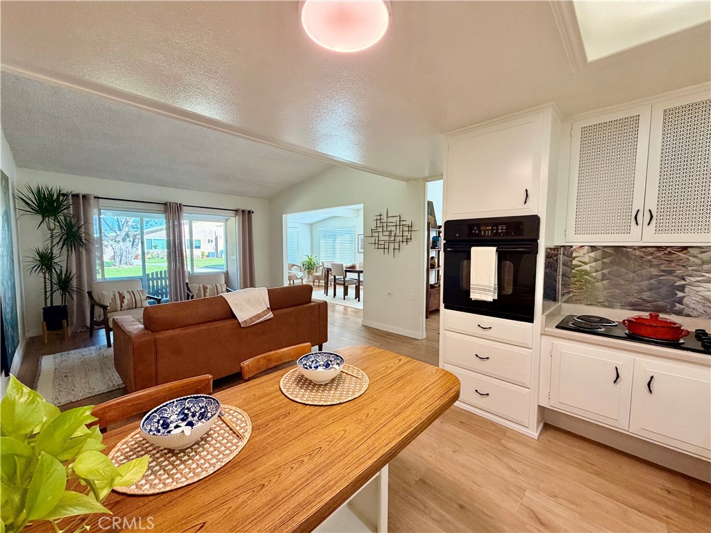 Kitchen with generous counter space, ample cabinetry, and an open connection to the living area. - 13560 Medinac Lane 102 L, Seal Beach CA 90740 - photo 9