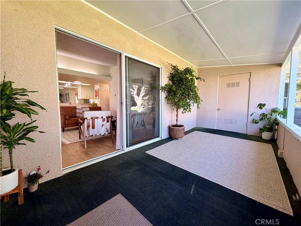 Private covered patio offering the perfect setting for outdoor relaxation and entertaining. - 13560 Medinac Lane 102 L, Seal Beach CA 90740 - photo 15
