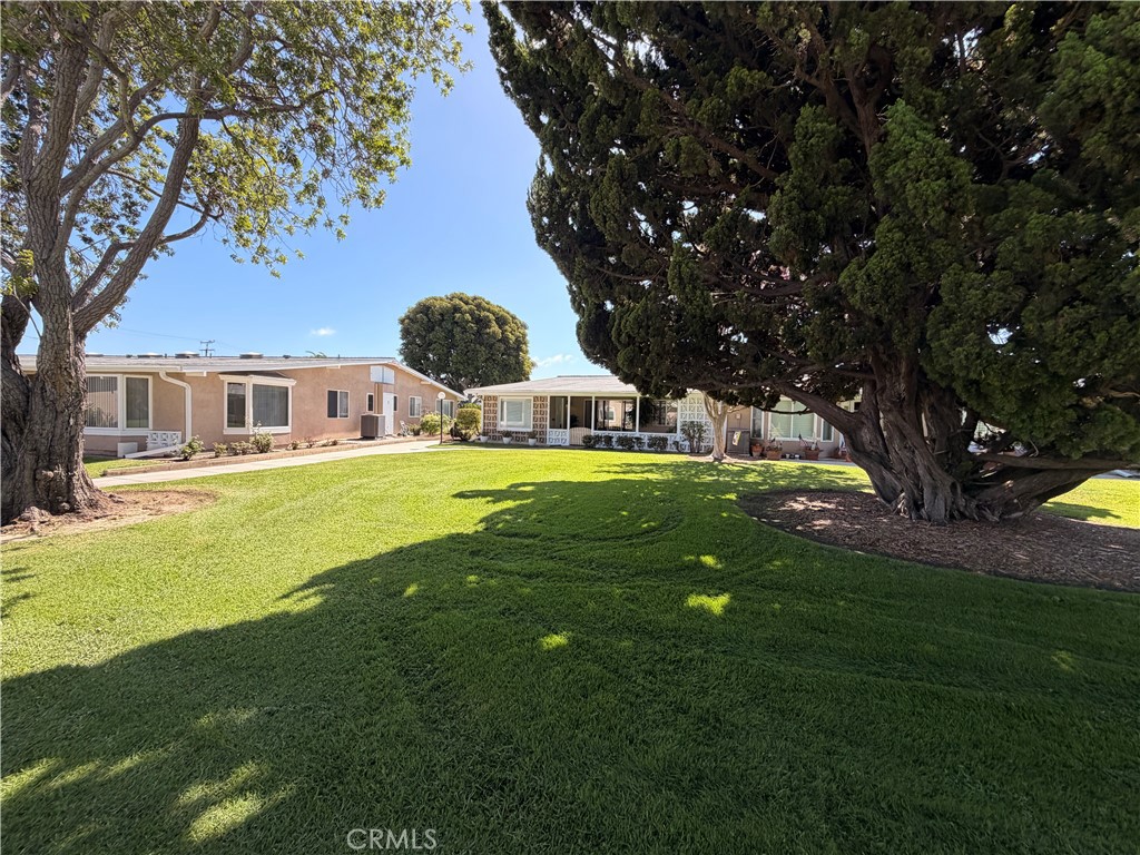 Expansive greenbelt setting with mature trees and beautifully maintained common grounds. - 13560 Medinac Lane 102 L, Seal Beach CA 90740 - photo 16