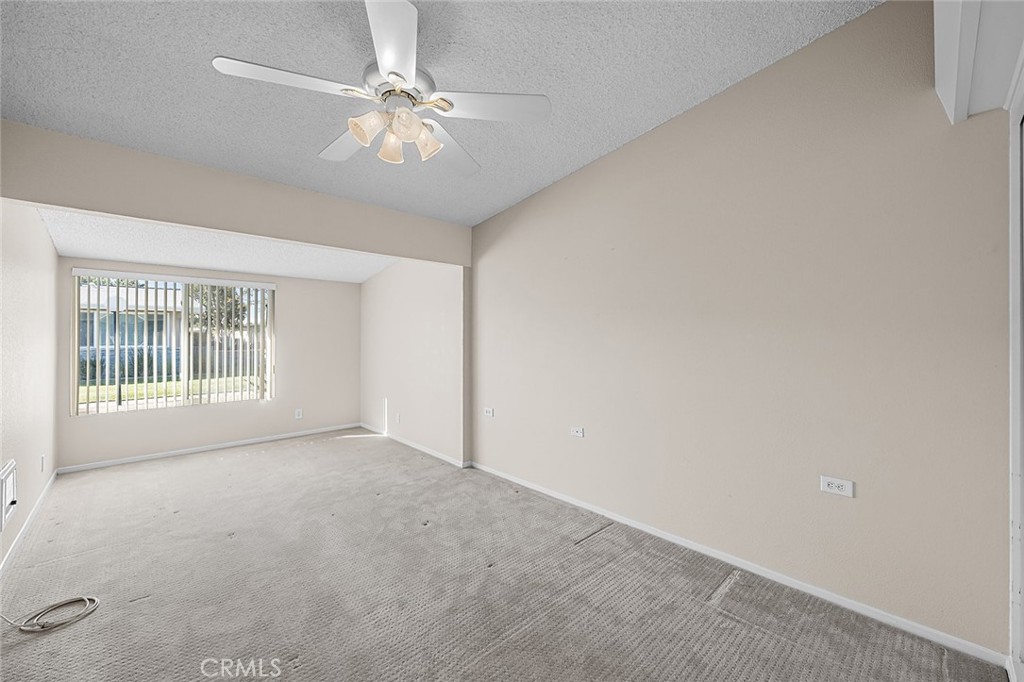 View into Primary Bedroom with Ceiling Fan - 1441 Homewood Road M5-96C, Seal Beach CA 90740 - photo 17