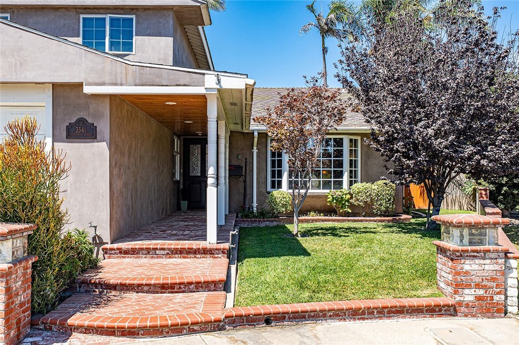 Gorgeous curb appeal with the smooth Santa Barbara stucco finish, brick hardscape, wood plank entry ceiling, beautiful t - 3541 Goldenrod, Seal Beach CA 90740 - photo 1