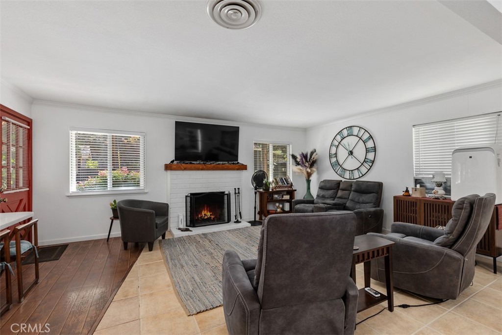 Living area looking towards wood burning fireplace for those chilly nights! AI enhanced fire. - 29501 Silverado Canyon Road, Silverado Canyon CA 92676 - photo 12