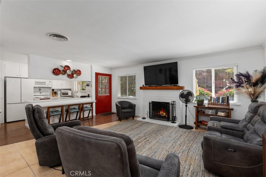 Living room looking towards kitchen. Kitchen seamlessly flows to living & dining room. AI enhanced fire - 29501 Silverado Canyon Road, Silverado Canyon CA 92676 - photo 14