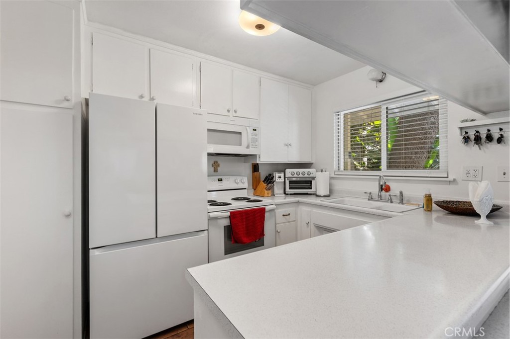 Kitchen is open & bright seamlessly flowing to both living & dining rooms - 29501 Silverado Canyon Road, Silverado Canyon CA 92676 - photo 15