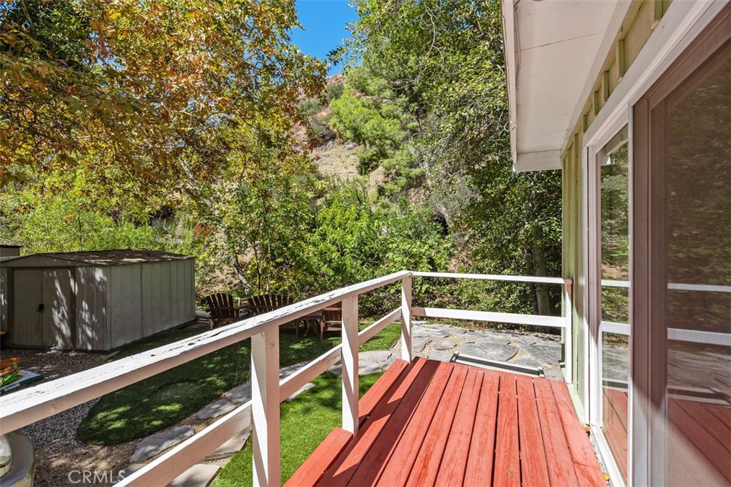 Deck off 2nd bedroom looking towards the back of the home where the serene creek runs. - 29501 Silverado Canyon Road, Silverado Canyon CA 92676 - photo 24