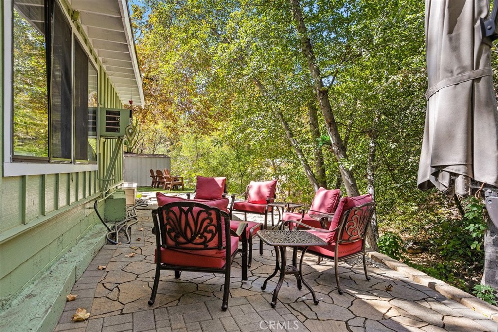 Back patio overlooks creek with a tiered area to the creek surrounded by oak & sycamore trees! - 29501 Silverado Canyon Road, Silverado Canyon CA 92676 - photo 36
