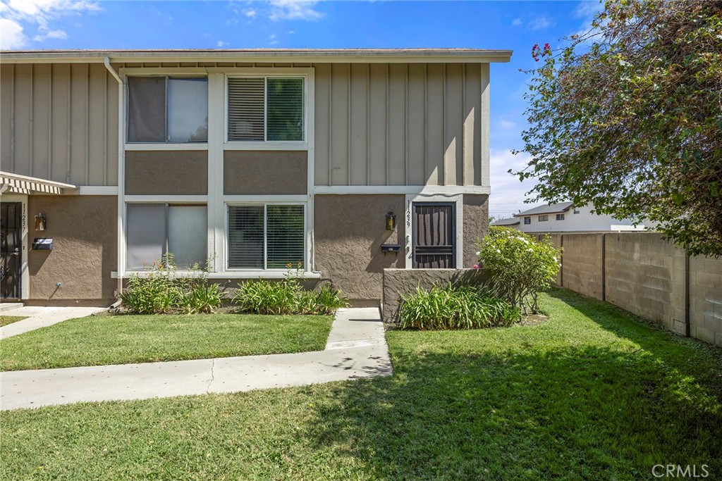 This end-unit home offers privacy, comfort and a wonderful sense of space. The grassy spaces feel like your own private - 11239 Dover Way, Stanton CA 90680 - photo 1