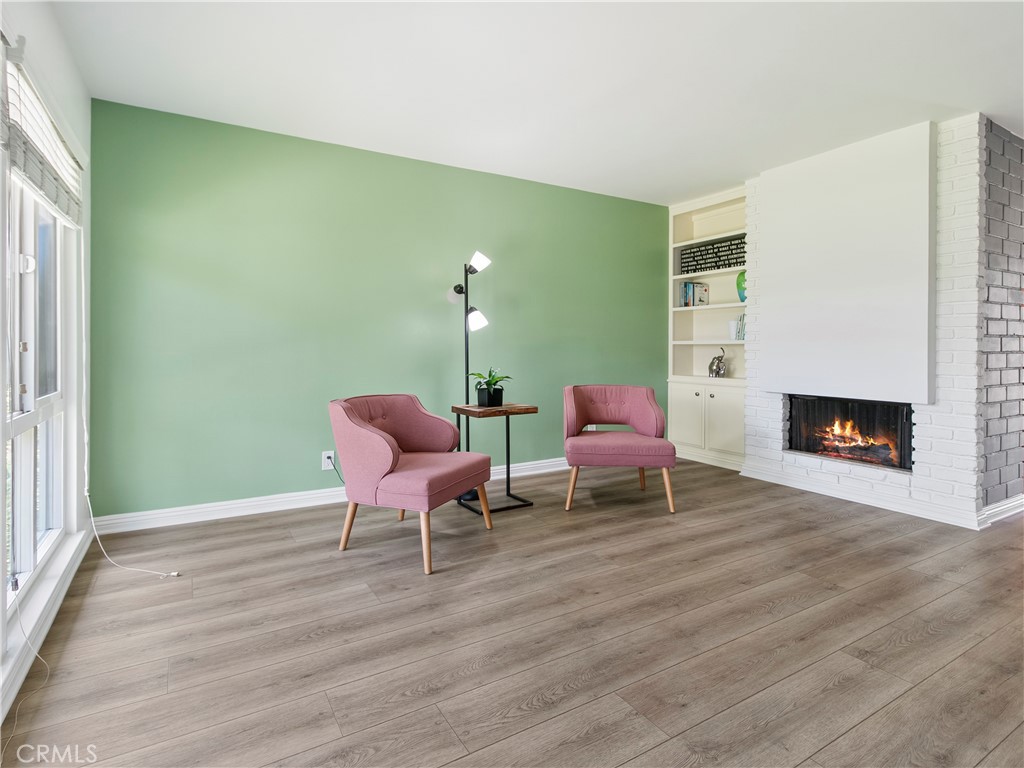 Living room with fireplace and built-in bookshelves - 1159 E 1st, Tustin CA 92780 - photo 9