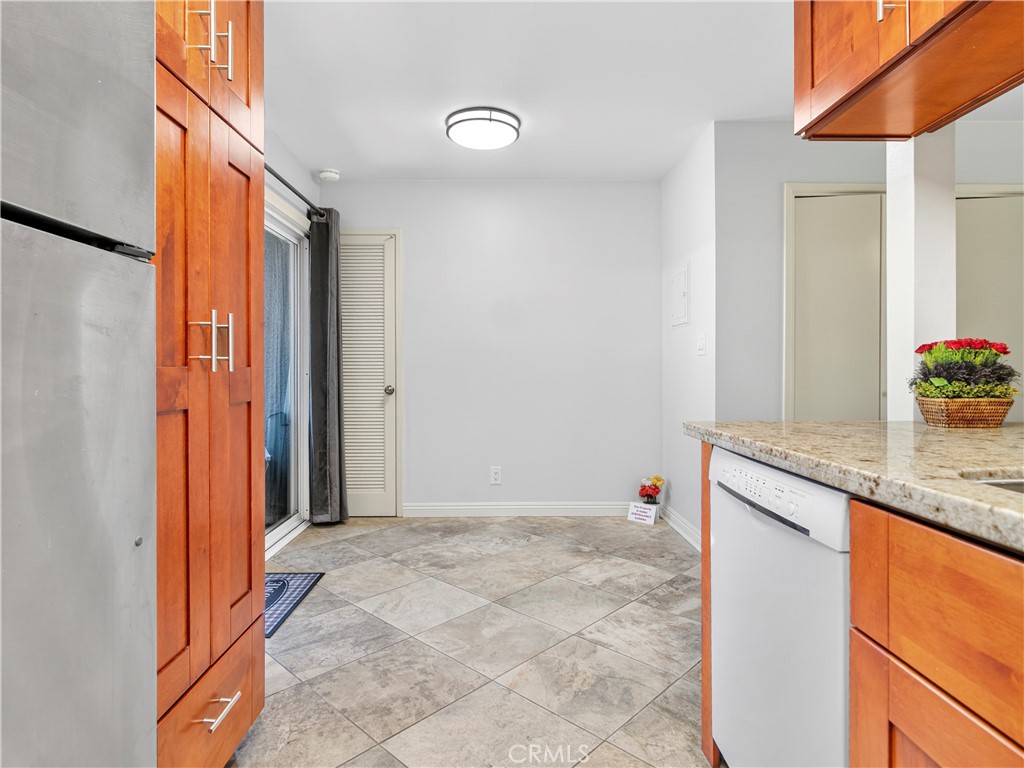 (Back patio entrance showing additional area at Entrance through newer vinyl sliding doors) - 1159 E 1st, Tustin CA 92780 - photo 12