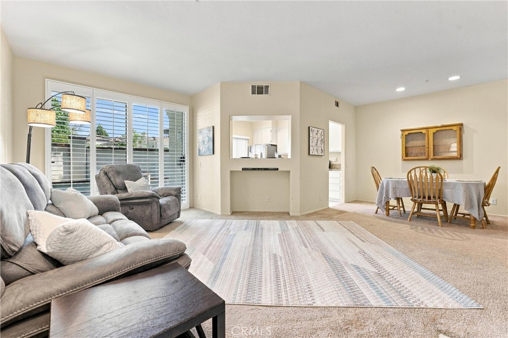 Living room showing the pass-through window from kitchen and dining area - 12591 Doral, Tustin CA 92782 - photo 4