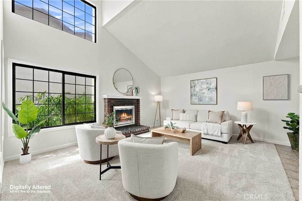 Open floor plan, tons of natural light, photo enhanced with fire in fireplace - 12620 Newport Avenue, Tustin CA 92780 - photo 2
