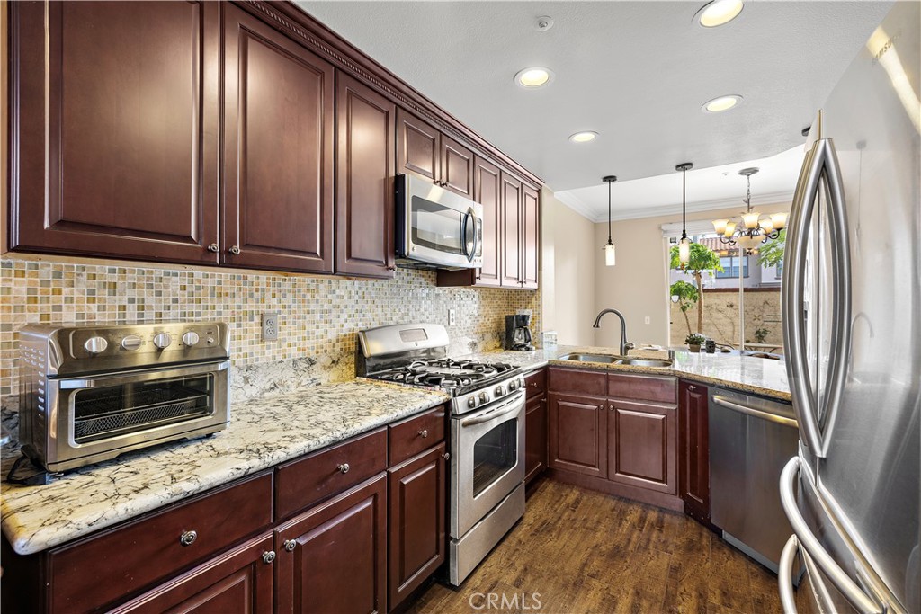 Kitchen with upgraded granite countertops and cabinetry - 13462 Savanna, Tustin CA 92782 - photo 12