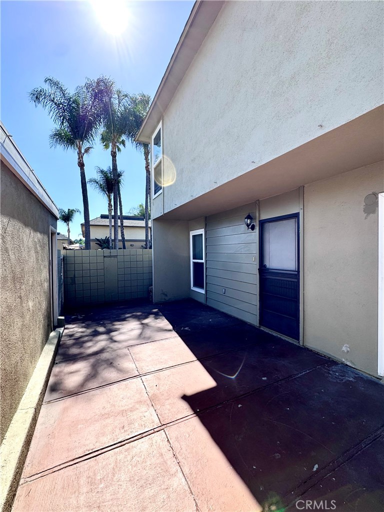 Back Patio area between garage and front door entrance - 14292 Red Hill Avenue, Tustin CA 92780 - photo 22