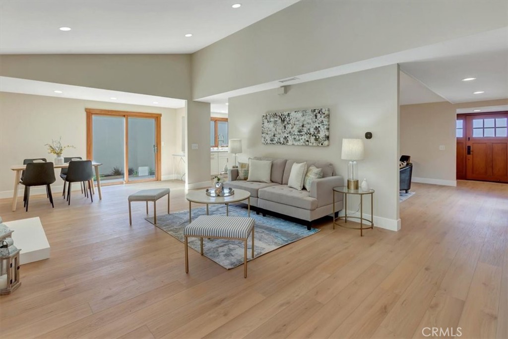 Living room with two sliders bringing in lots of light; crackling fireplace, vaulted ceiling - 14412 GRASSMERE, Tustin CA 92780 - photo 7