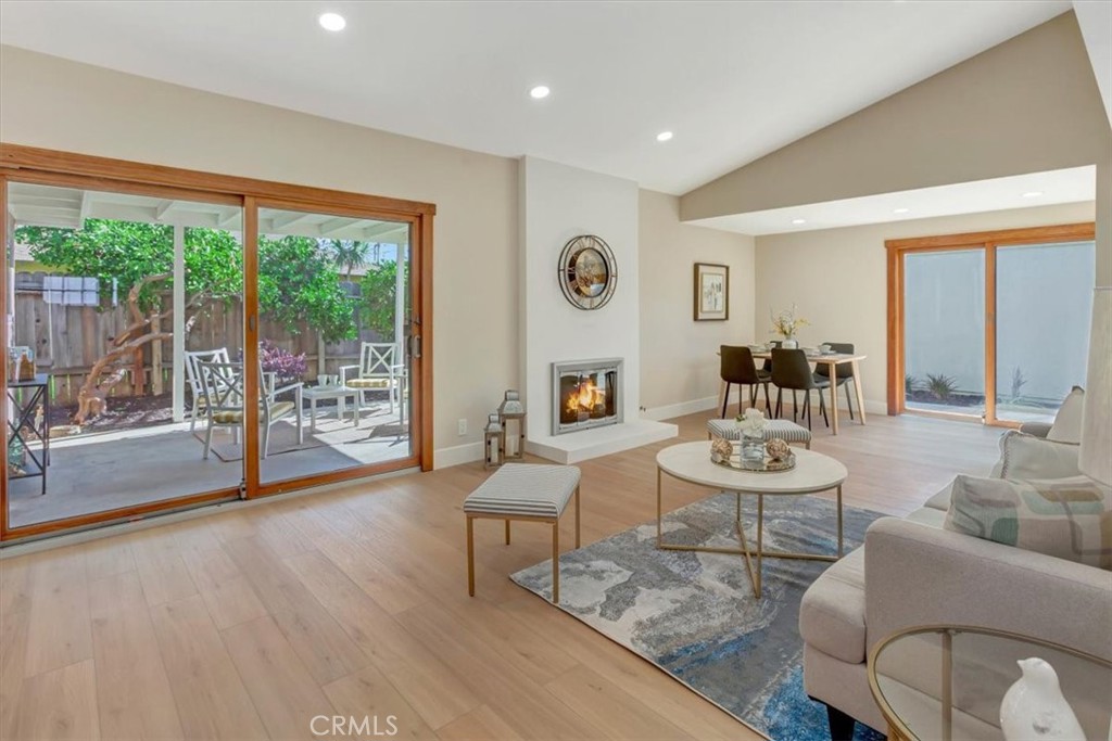 Living room opens to covered back yard patio and lots of green landscaping - 14412 GRASSMERE, Tustin CA 92780 - photo 8