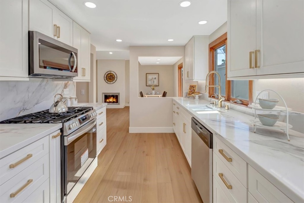 ALL NEW kitchen cabinets, quartz backsplash, under cabinet lighting, large windows bringing in lots of natural light - l - 14412 GRASSMERE, Tustin CA 92780 - photo 13