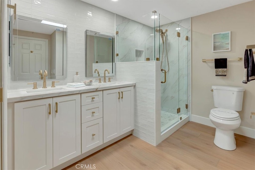 ALL NEW primary bathroom, tiled backsplash and custom shower, new toilet, electrical receptacle inside drawer for conven - 14412 GRASSMERE, Tustin CA 92780 - photo 18