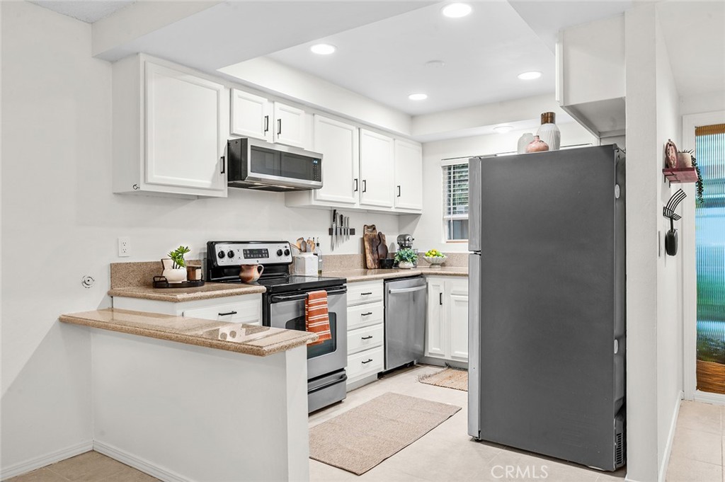 Bright kitchen with ample cabinet space - 1881 Mitchell Avenue 135, Tustin CA 92780 - photo 7