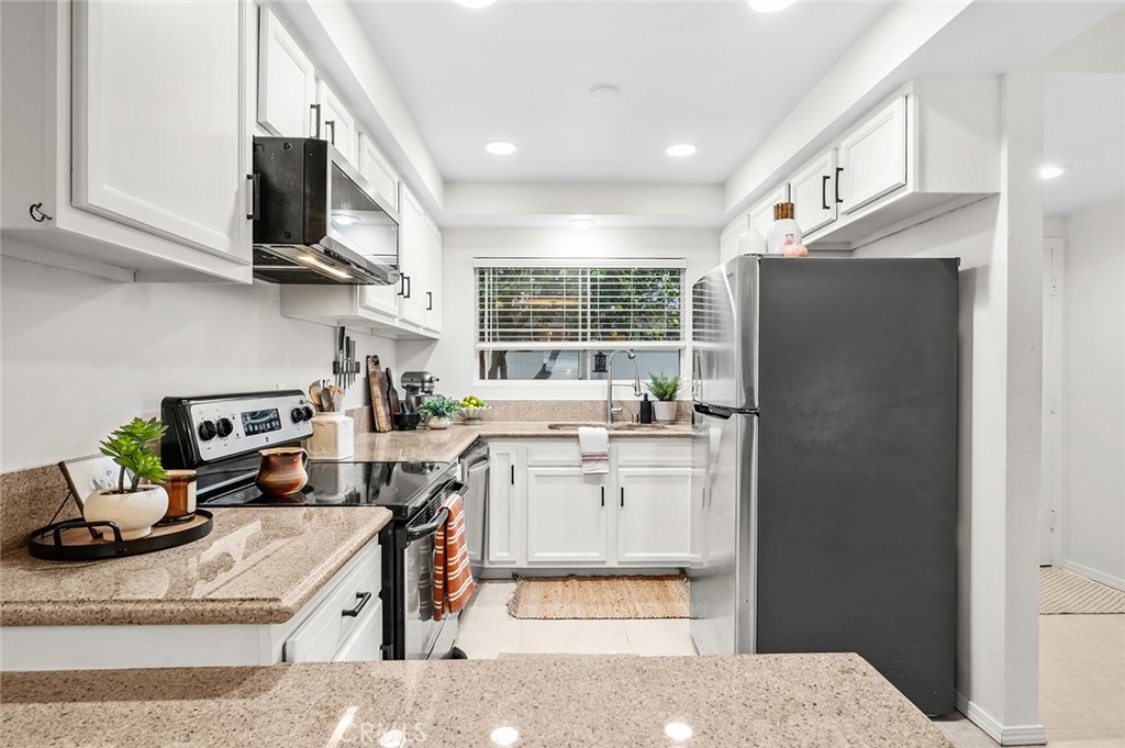 Bright kitchen with ample cabinet space - 1881 Mitchell Avenue 135, Tustin CA 92780 - photo 8